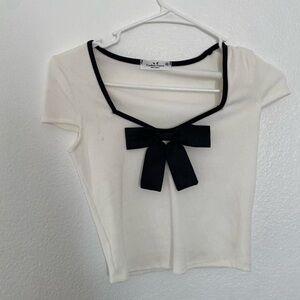 Elegant White Top with Black Bow Accent